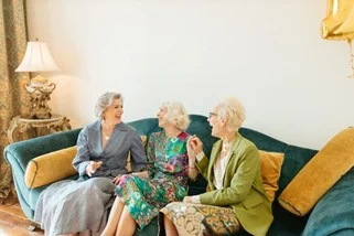 3 elderly woman sitting on a green couch